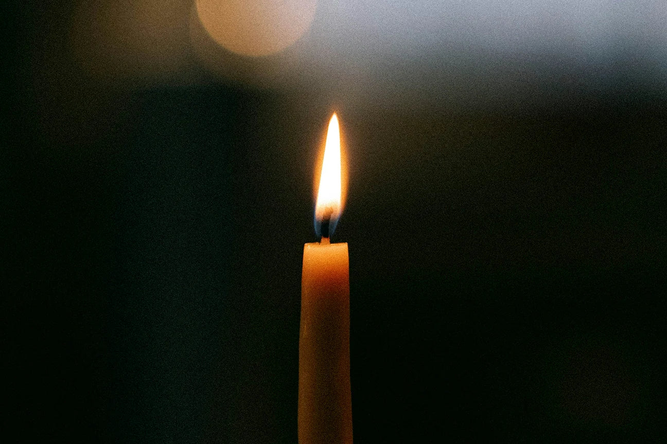 Intention candle with lit flame for intention setting rituals