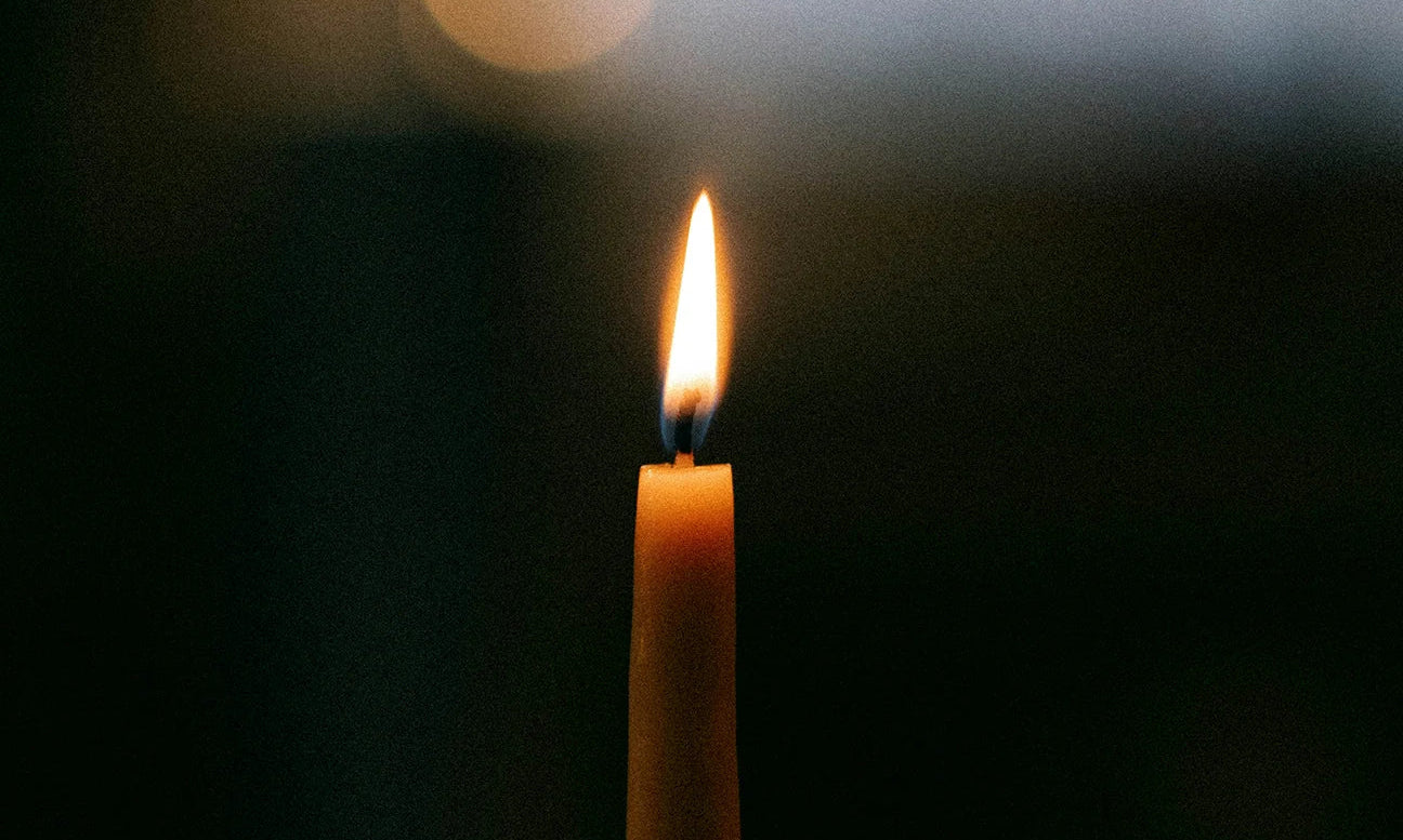 Intention candle with lit flame for intention setting rituals