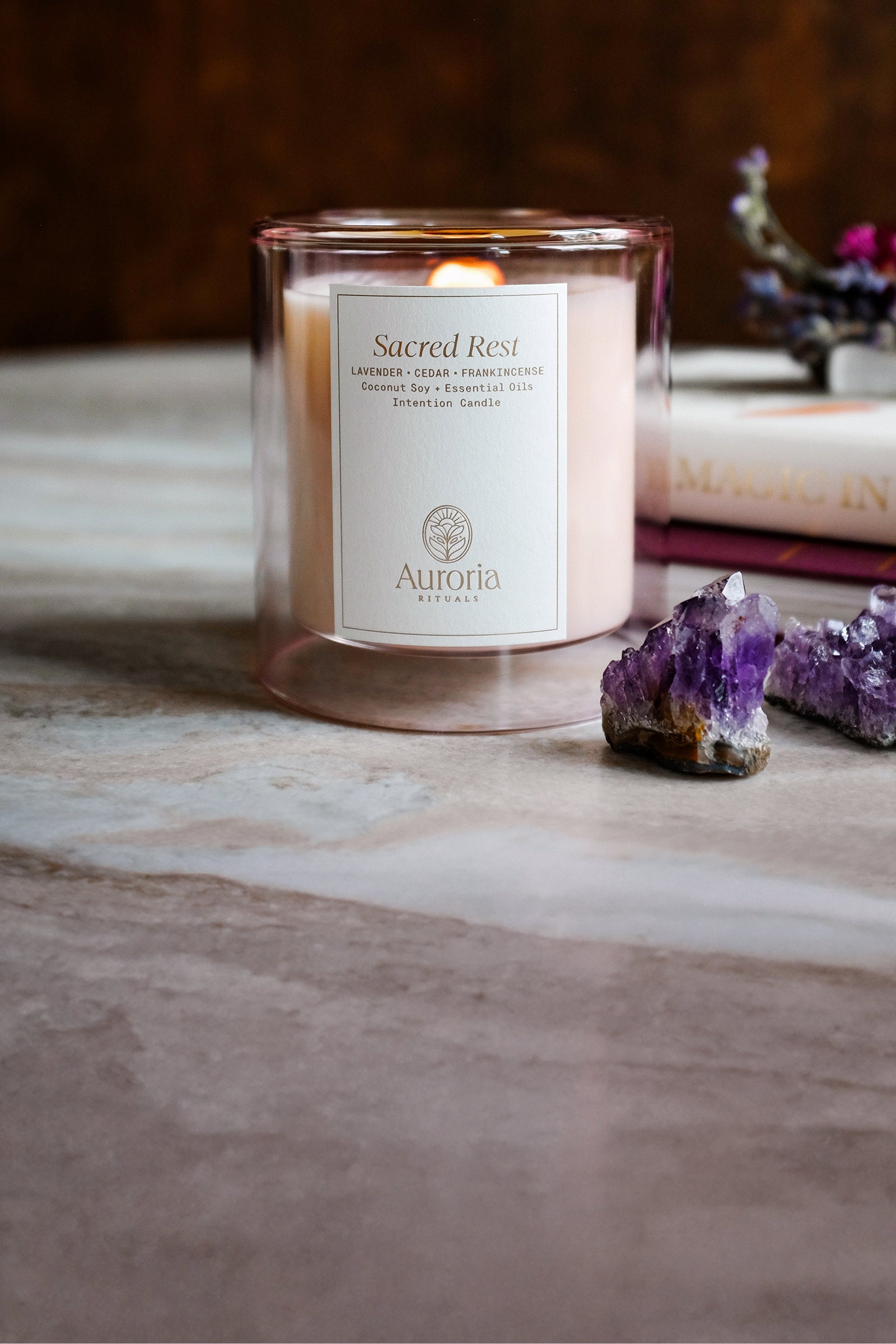 Auroria Rituals Sacred Rest Intention candle made with pure essential oils next to amethyst crystal